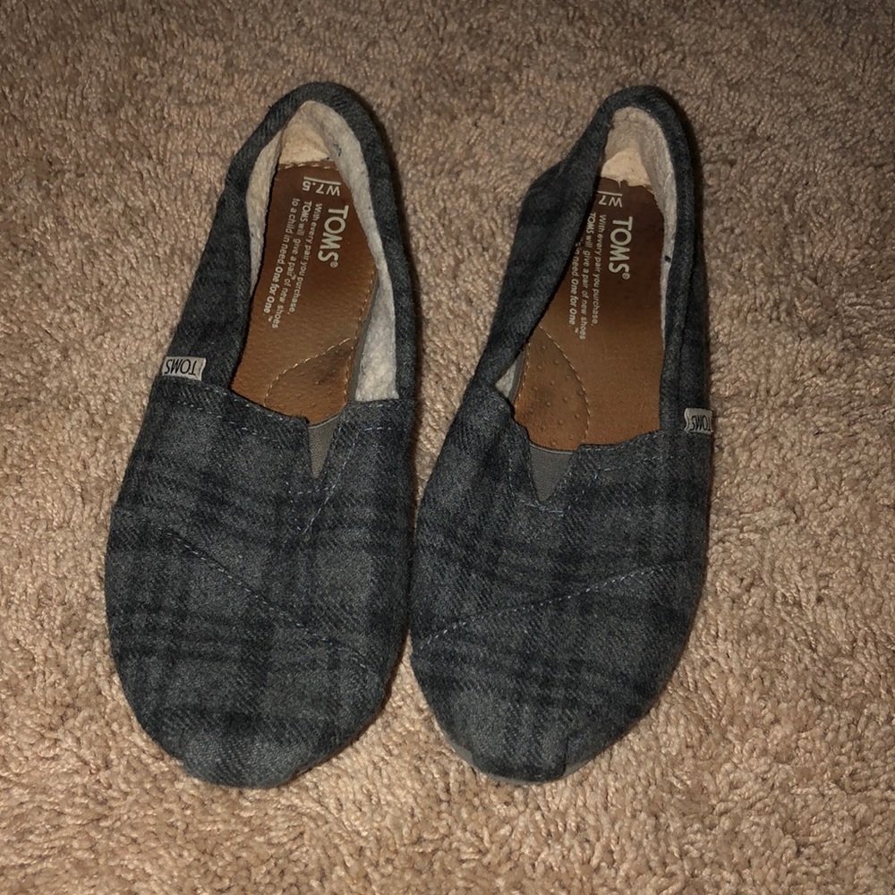 Women’s black and grey plaid Toms.
